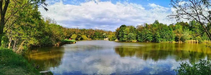 Paris, France - May, 2022: View of lower lake in the Bois de Boulogne and reflections of the nature