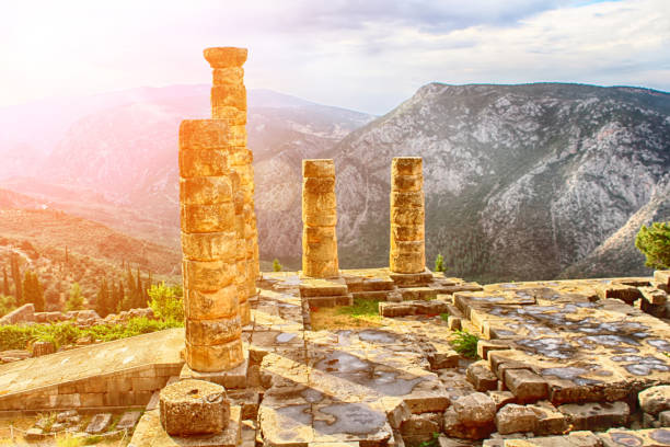 The Temple of Apollo in Delphi, Greece. Sunrise. Sun beam The Temple of Apollo in Delphi, Greece. Sunrise. Sun beam oracle building stock pictures, royalty-free photos & images