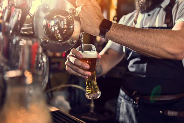 istock Bartender pouring beer from beer tap in a bar 1224442743