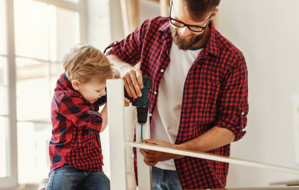 istock Happy father and son assembling furniture on table 1224443751