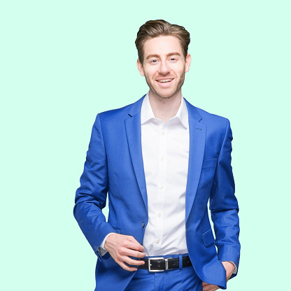 Waist up of aged 20-29 years old who is slim with short hair caucasian young male businessman standing wearing button down shirt who is showing cool attitude