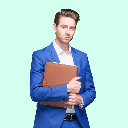 One person of aged 20-29 years old who is slim with short hair caucasian young male business person standing wearing shirt who is confident and holding contract