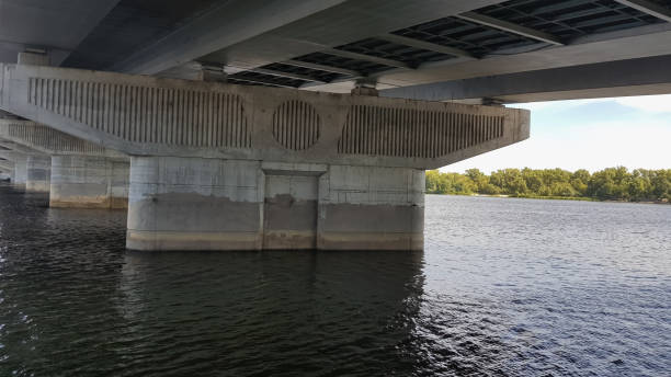 istock Close-up concrete support of an iron bridge in a river 1224445968