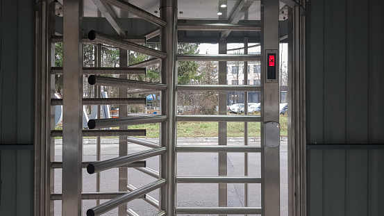 Full-size turnstile, guarded entrance. Revolving door. Card key, rotating entrance with card pass system