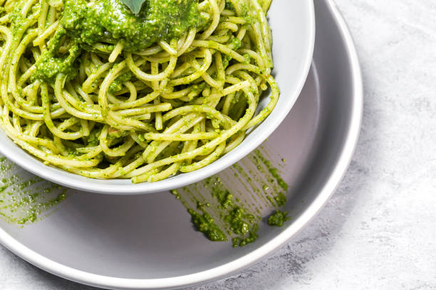istock Spaghetti with homemade pesto sauce on gray background 1224447364