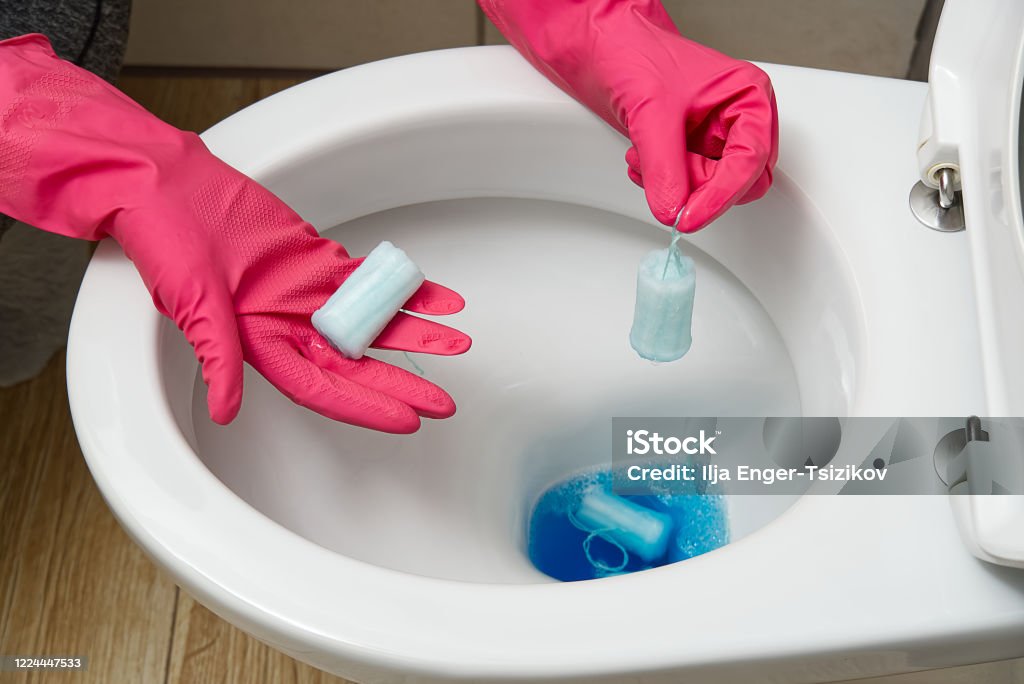 do not throw foreign objects, sanitary pads, tampons, paper, plastic into the toilet. Close-up of a toilet bowl clogged do not throw foreign objects, sanitary pads, tampons, paper, plastic into the toilet. Close-up of a toilet bowl clogged. Bathroom Stock Photo