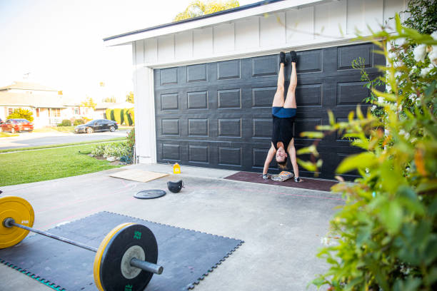 istock Fit woman doing hand stand at her garage 1224449185