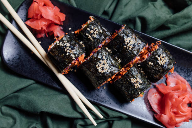 istock vegetarian sushi on green background, top view, 1224449963
