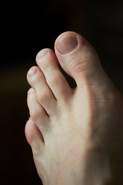 istock Close-up left male foot on dark background, selective focus 1224450784