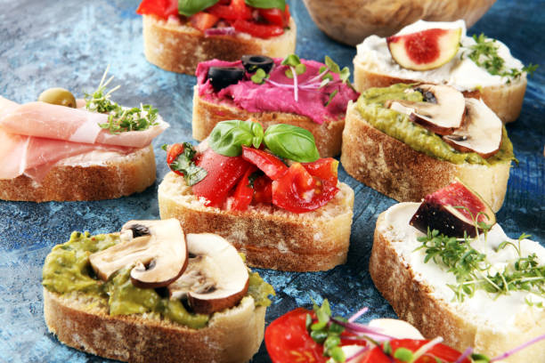 istock Assorted bruschetta with various toppings. Appetizing bruschetta or crudo crostini. Variety of small sandwiches. Mix bruschetta with tomatoes and basil 1224451646