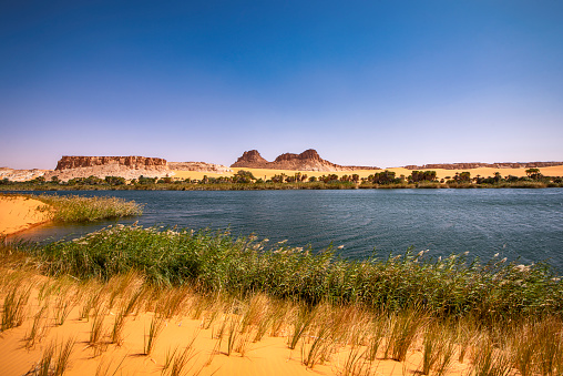 Ounianga Sérir Lake, one of the legendary Lakes of Ounianga in North-Eastern Chad. These remote lakes are definetely one of the greatest natural wonders on our planet. In the middle of the endless Sahara Desert, actually in a basin between the  mountains of Western Tibesti and the Eastern Ennedi massif there is a total of 18 lakes. All togehter the lakes are covering a surface of approx. 20 square kilometers. The Lakes of Ounianga were declared as an UNESCO World Heritage site in 2012.