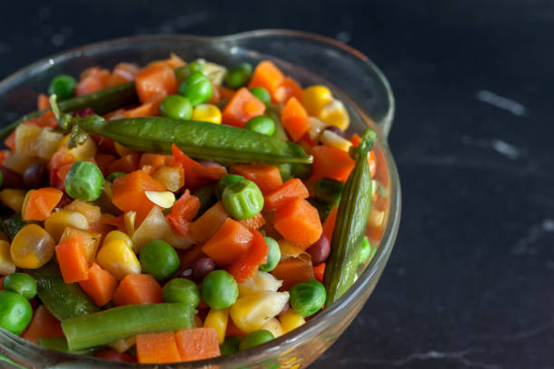istock steamed vegetables on plate at dark background 1224454537