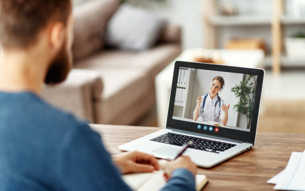 istock Man listening to online doctor and making notes 1224454817