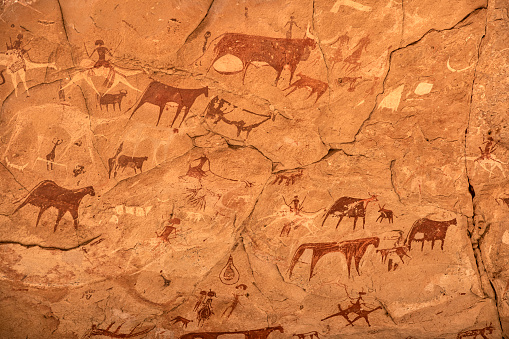 Prehistoric rock painting art in a cave in the remote Ennedi Mountains in the Sahara desert, North-East Chad. This famous rock art images can be dated to around 5000 BC onwards. The Ennedi massif was declared as an UNESCO World Heritage site in 2016.