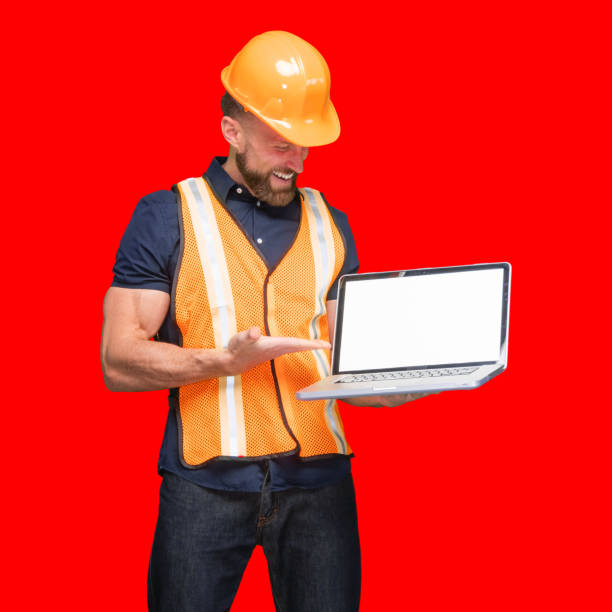 istock Caucasian male standing in front of colored background and using laptop 1224458162