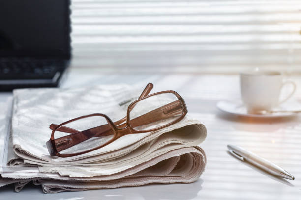 istock newspaper and glasses over office desk 1224458312