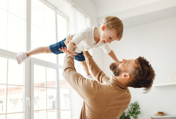 istock Happy man with little son having fun at home 1224459308