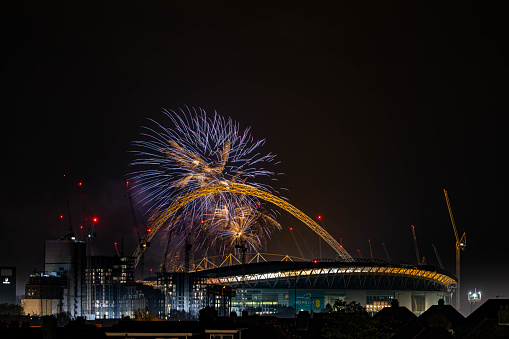 The arch with fireworks nigh in Wembley Park, London Borough of Brent, UK.