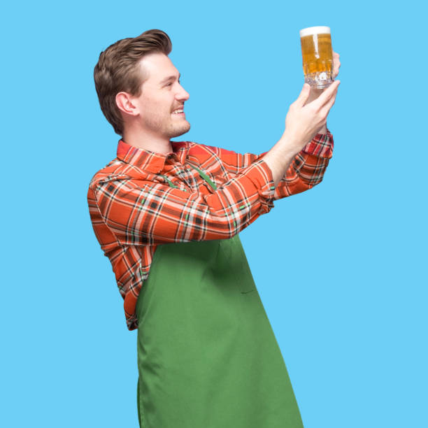 istock Brewmaster -  caucasian young male manual worker standing wearing button down shirt and holding mug 1224466836