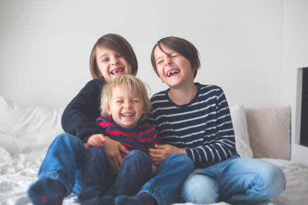 istock Three children, boy brothers, laughing in bed 1224468256