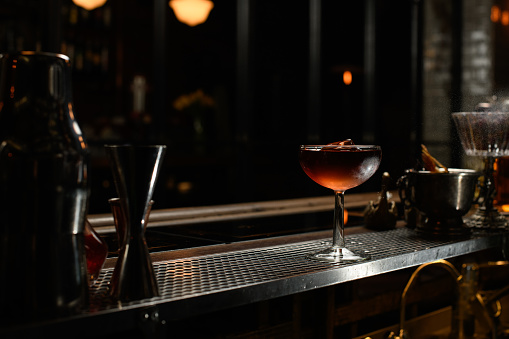 Two glasses of classic martinis with ice on a hot Summer day. Selective focus on the foreground glass.