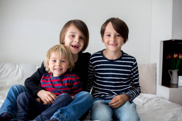 istock Three children, boy brothers, laughing in bed 1224468514