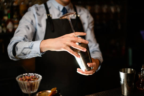 istock bartender holds in his hands steel shaker and empty glass 1224469969