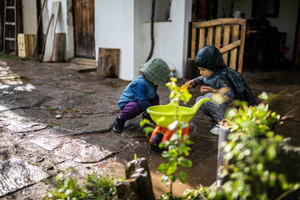 istock Cute kids playing in back yard after rain 1224472912