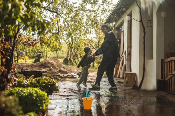 istock Father and son enjoying on rainy day in front yard 1224472989