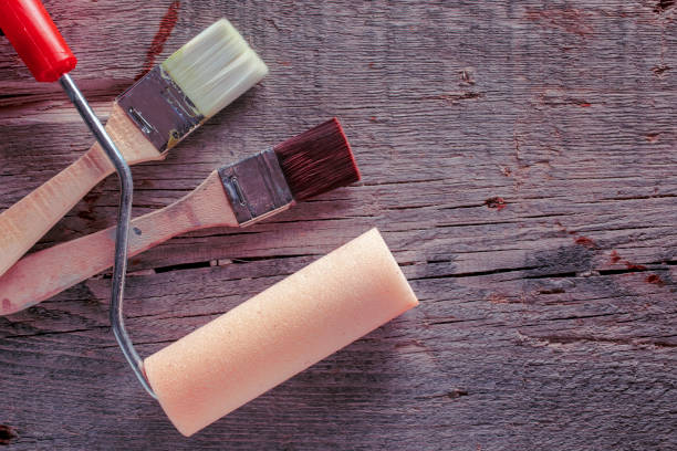 istock Clean paint roller and two paintbrush on old wood. Copy space for text. 1224474334