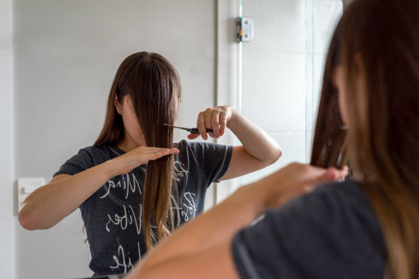 istock Woman cutting her own bangs 1224474481