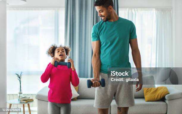 Father And Daughter Exercising At Home Stock Photo - Download Image Now - Father, Exercising, Home Workout
