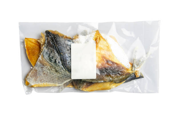 istock Dried bream in form butterfly in a transparent package with a white label appetizer to beer isolated on white background. Snack Fish to beer. Close up 1224475993