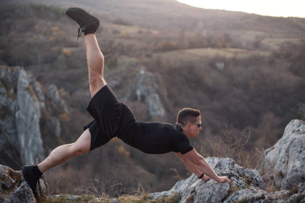 istock Strong man stretching after a workout on mountain 1224476105