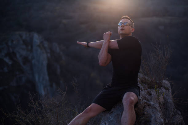 Strong man after a hard exercise on the mountain top