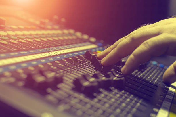 istock Human hand on the mixing console in the recording Studio. Spotlight. 1224477124
