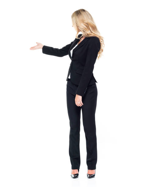 istock Caucasian female presenter standing in front of white background 1224477434