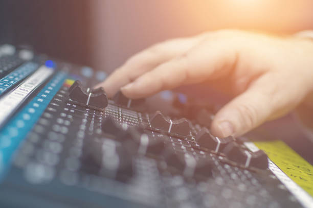 istock Human hand on the mixing console in the recording Studio. Spotlight. 1224478735