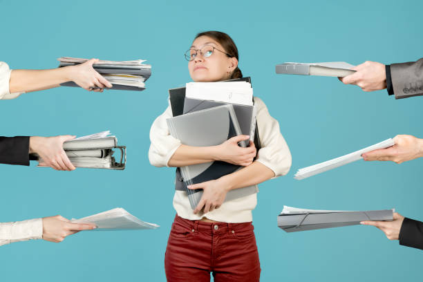 istock Girl hugs a large stack of documents and folders 1224480475