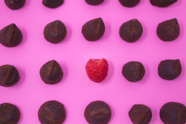 Solo raspberry amongst rows of truffles