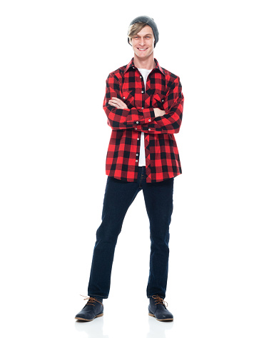 Full length of aged 20-29 years old caucasian male hipster standing in front of white background wearing jeans who is successful with arms crossed