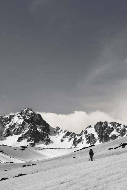 istock Hiker on snowy plateau, snow covered mountain range and sunlit sky 1224481117