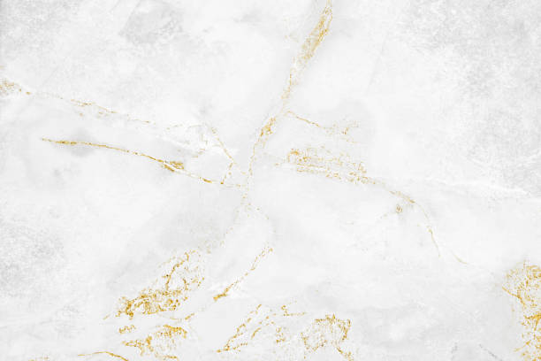 White and gold marble luxury wall texture with shine golden line pattern abstract background design for a cover book or wallpaper and banner website. White and gold marble luxury wall texture with shine golden line pattern abstract background design for a cover book or wallpaper and banner website. ivory material stock pictures, royalty-free photos & images