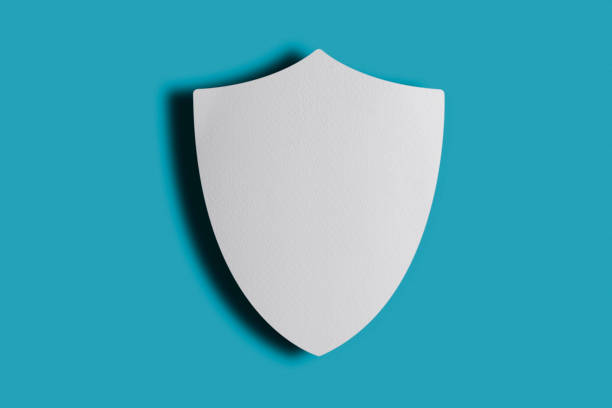 Blank White Paper Shield On Blue Background. Horizontal composition with copy space and clipping path is included.\nReady for your design.