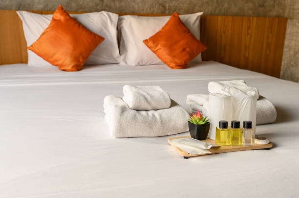 istock Set of hotel amenities (such as towels, shampoo, soap, drinking glass etc) on the bed. 1224490857