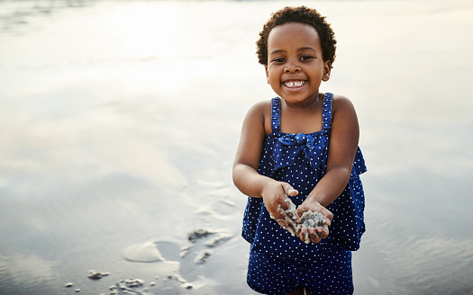 Shot of an adorable little girl having fun on the beach