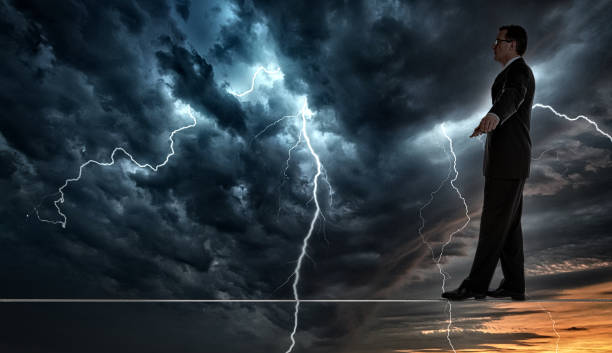 istock Businessman Walking a Tightrope in Thunderstorm 1224492023