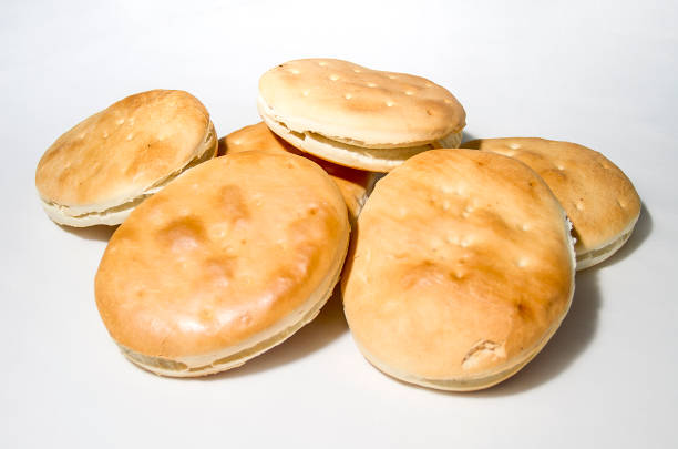 Chilean Homemade rustic fresh Hallulla bread on white background. Fresh Bread hand made close up. Bakery, food concept.