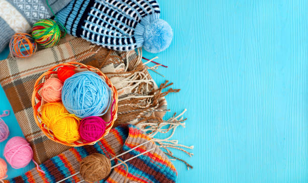 istock Yarn and knitted clothes on a blue background. 1224495788