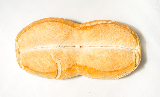 Chilean Homemade rustic fresh Marraqueta bread on white background. Fresh Bread hand made close up. Bakery, food concept.